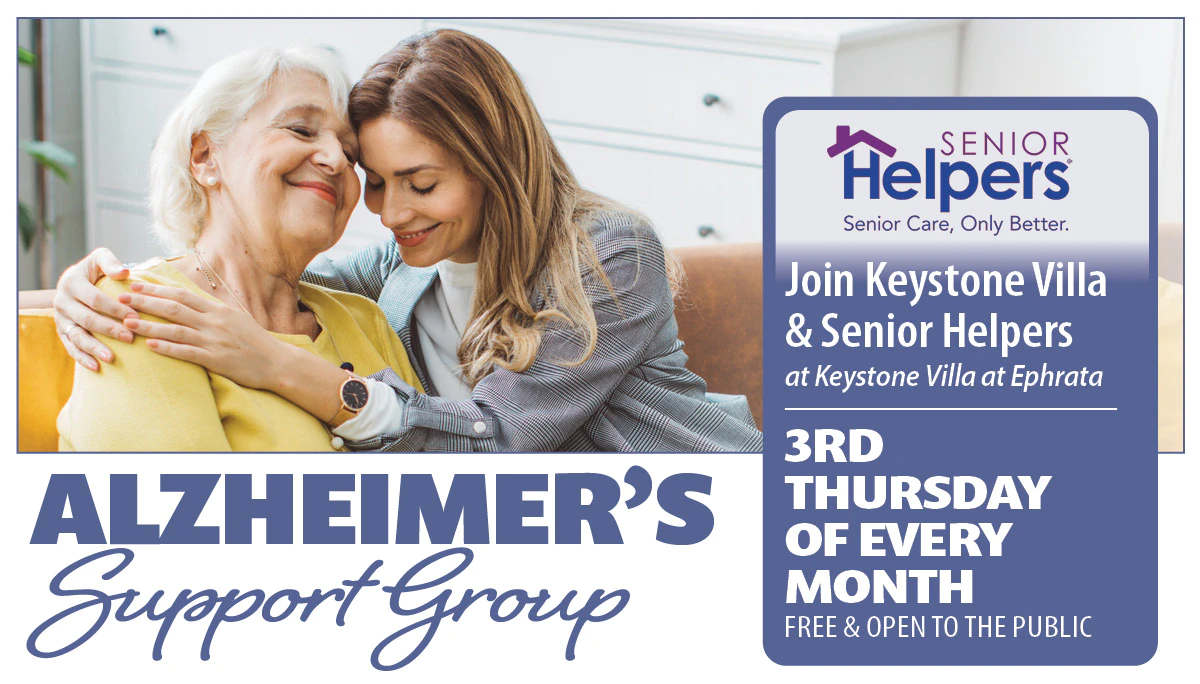 Caregiver hugging elderly woman for Alzheimer’s support group