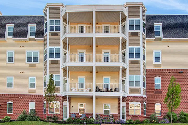 Multi-story apartment building with balconies and brick facade