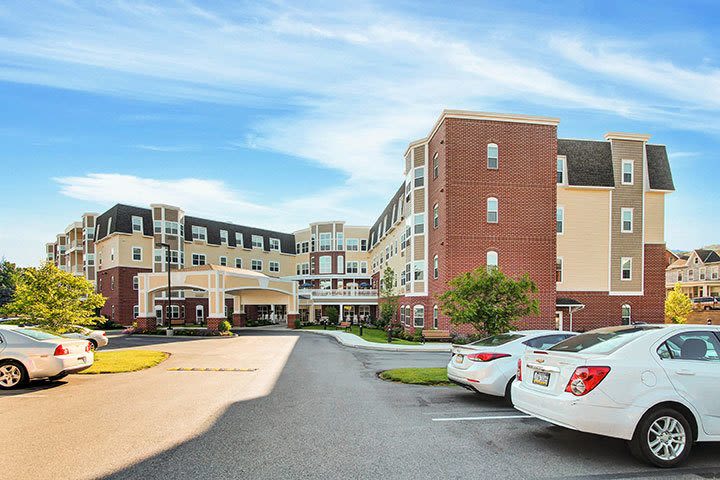 Large brick apartment building with parking lot
