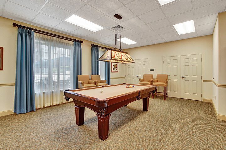 Billiards room with pool table and seating