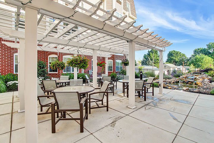 Outdoor patio with pergola and garden waterfall